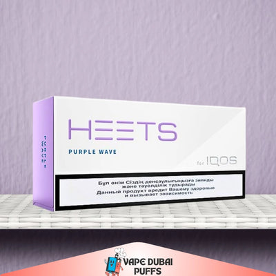 HEETS Purple Wave packaging for IQOS on a gray surface with a purple background