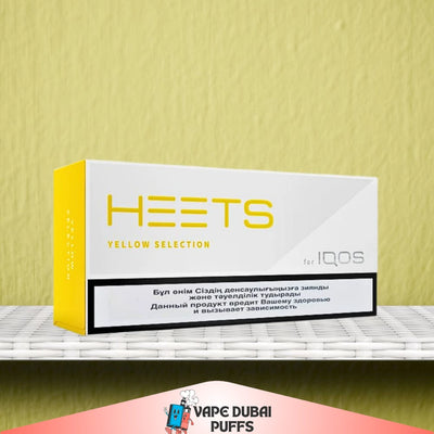 HEETS Yellow Selection for IQOS packaging on a shelf with a yellow wall background