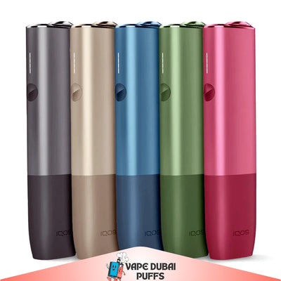 Five colorful IQOS Iluma One Kit devices in a row on a white background with 'Vape Dubai' logo at the bottom.