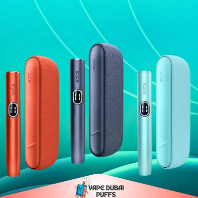 IQOS Iluma i Standard devices and cases in different colors on a teal background with 'Vape Dubai' branding.